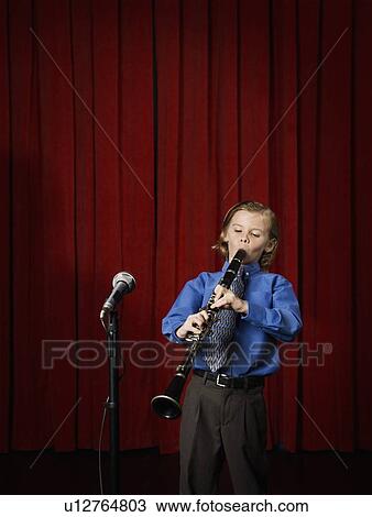 Boy playing clarinet on stage View Large Photo Image Stock Image - Boy playing clarinet on stage. Fotosearch