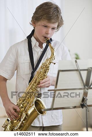 Boy playing saxophone View Large Photo Image Stock Image - Boy playing saxophone. Fotosearch