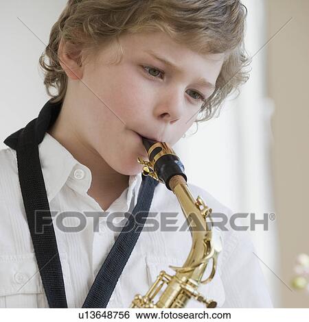Boy playing saxophone View Large Photo Image Stock Photograph - Boy playing saxophone. Fotosearch
