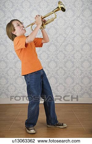 Stock Image - Boy playing trumpet. Fotosearch