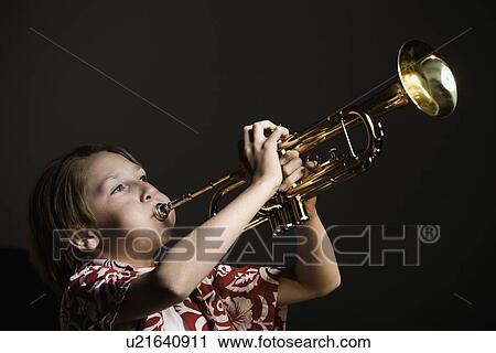 Stock Image - Boy playing trumpet. Fotosearch