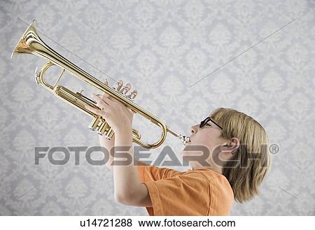 Stock Photo - Boy playing trumpet. Fotosearch