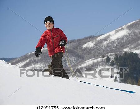 Boy pulling sled in snow View Large Photo Image Stock Photography - Boy pulling sled in snow. Fotosearch