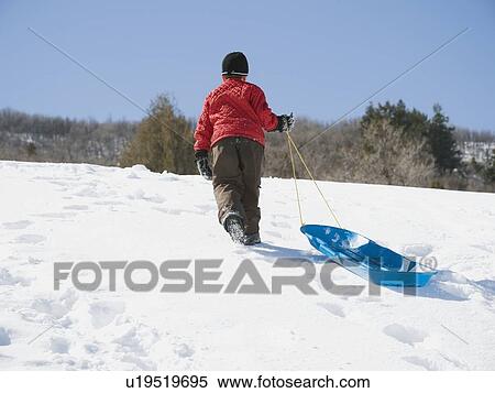 Boy pulling sled in snow View Large Photo Image Stock Photography - Boy pulling sled in snow. Fotosearch