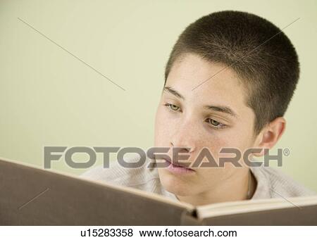 Stock Photo - Boy reading book. Fotosearch
