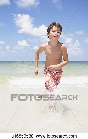 Boy running in ocean View Large Photo Image Stock Photo - Boy running in ocean. Fotosearch