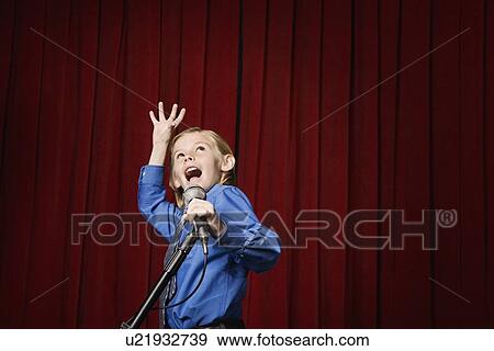 Boy singing on stage View Large Photo Image Stock Photo - Boy singing on stage. Fotosearch