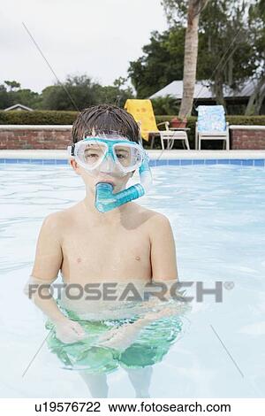 Stock Image - Boy snorkeling in swimming pool. Fotosearch