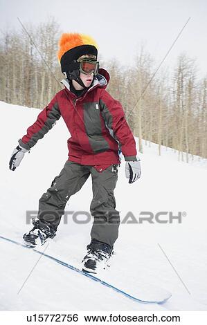 Stock Photograph - Boy snowboarding downhill. Fotosearch