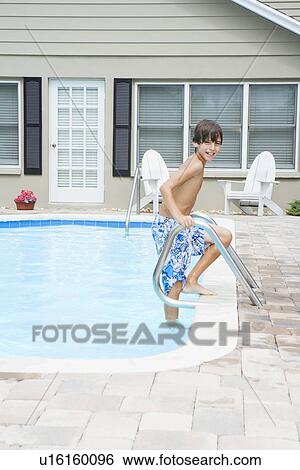 Boy stepping out of swimming pool View Large Photo Image Stock Photograph - Boy stepping out of swimming pool. Fotosearch