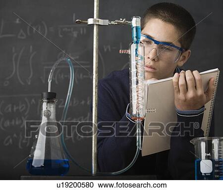 Stock Image - Boy taking notes in science class. Fotosearch
