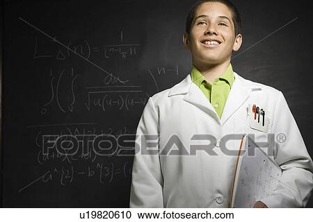 Boy wearing lab coat in front of blackboard View Large Photo Image Stock Image - Boy wearing lab coat in front of blackboard . Fotosearch