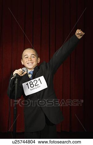 Boy wearing number and cheering on stage View Large Photo Image Picture - Boy wearing number and cheering on stage. Fotosearch