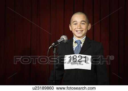 Stock Image - Boy wearing number on stage. Fotosearch