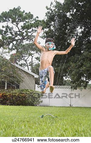 Boy with snorkeling mask running through sprinkler View Large Photo Image Stock Image - Boy with snorkeling mask running through sprinkler. Fotosearch