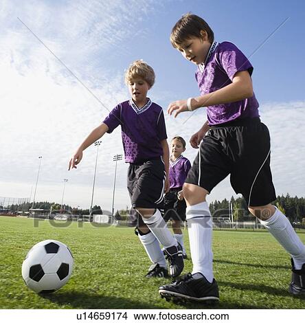 Picture - Boys playing competitive soccer. Fotosearch