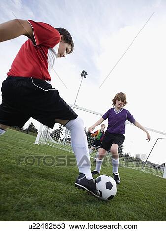 Boys playing competitive soccer View Large Photo Image Stock Image - Boys playing competitive soccer. Fotosearch