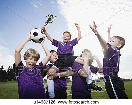 Boys soccer team celebrating with trophy View Large Photo Image Stock Photograph - Boys soccer team celebrating with trophy. Fotosearch