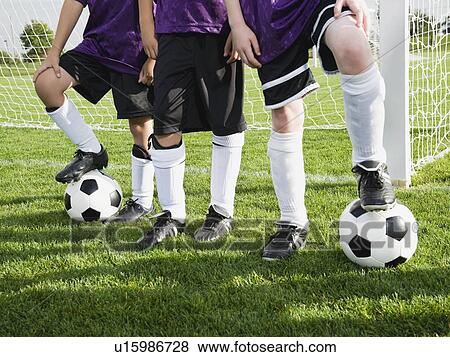 Boys standing near goal on soccer field View Large Photo Image Stock Photo - Boys standing near goal on soccer field. Fotosearch