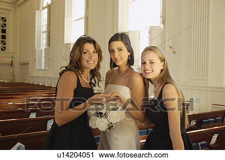 Bride and bridesmaids in church View Large Photo Image Stock Image - Bride and bridesmaids in church. Fotosearch