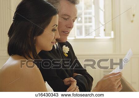 Stock Image - Bride and father reading letter. Fotosearch