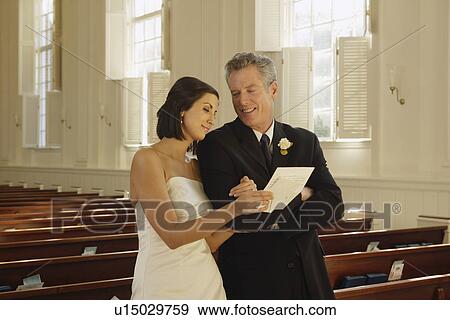 Stock Photo - Bride and father reading letter. Fotosearch