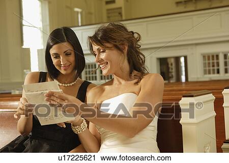 Bride and friend reading letter View Large Photo Image Stock Image - Bride and friend reading letter. Fotosearch