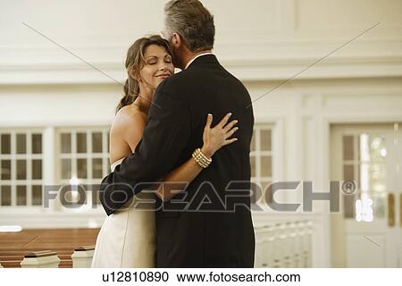 Stock Image - Bride and groom hugging. Fotosearch