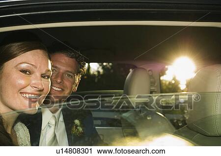 Stock Image - Bride and groom in limousine. Fotosearch