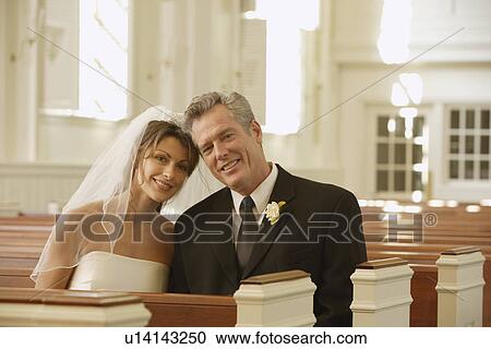 Bride and groom sitting in church View Large Photo Image Stock Image - Bride and groom sitting in church. Fotosearch