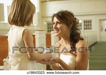 Bride giving gift to flower girl View Large Photo Image Stock Image - Bride giving gift to flower girl. Fotosearch