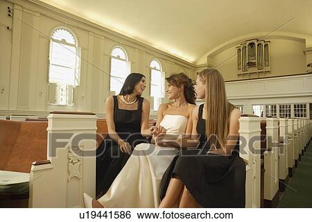 Stock Photograph - Bride laughing with friends. Fotosearch