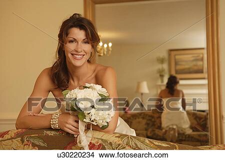 Picture - Bride leaning on sofa. Fotosearch