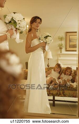 Stock Photography - Bride looking in mirror. Fotosearch