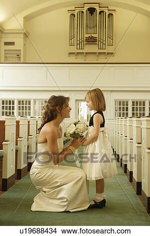 Bride talking to flower girl View Large Photo Image Picture - Bride talking to flower girl. Fotosearch