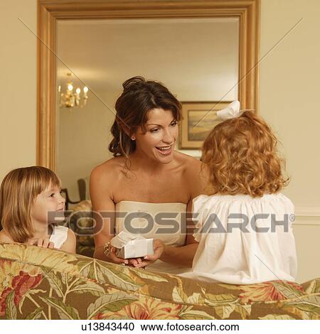 Stock Image - Bride talking to flower girls. Fotosearch