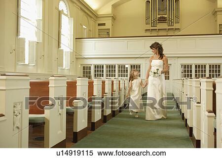 Bride walking down aisle with flower girl View Large Photo Image Stock Photography - Bride walking down aisle with flower girl. Fotosearch
