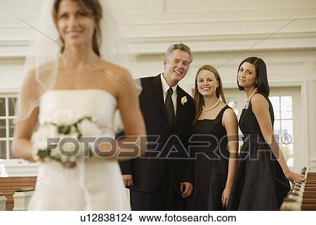 Picture - Bride with family in background. Fotosearch