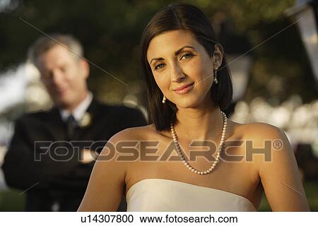 Stock Image - Bride with father in background. Fotosearch