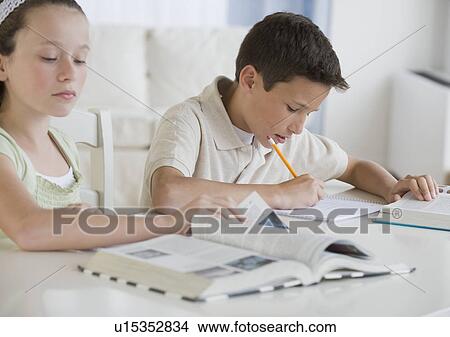 Picture - Brother and sister doing homework. Fotosearch