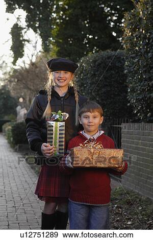 Brother and sister holding gifts View Large Photo Image Stock Photo - Brother and sister holding gifts. Fotosearch