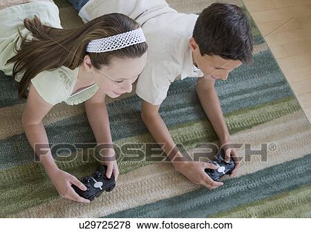 Stock Photo - Brother and sister playing video games. Fotosearch