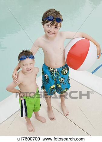 Brothers posing by swimming pool View Large Photo Image Stock Image - Brothers posing by swimming pool. Fotosearch