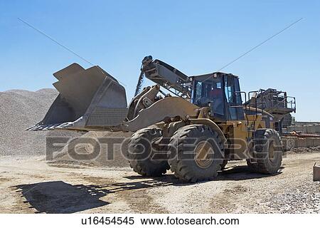 Stock Photography - Bucket loader in gravel yard. Fotosearch