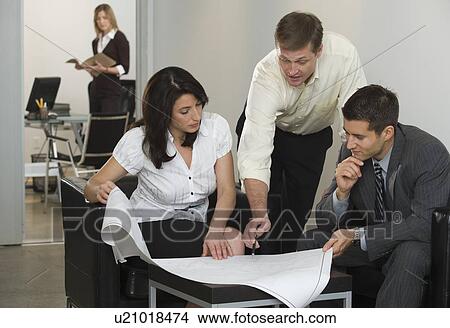 Business people examining blueprints View Large Photo Image Picture - Business people examining blueprints. Fotosearch