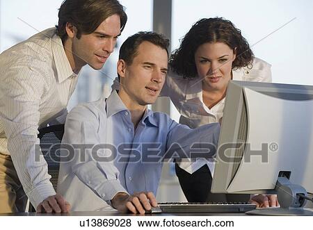 Stock Photo - Business people working at computer. Fotosearch