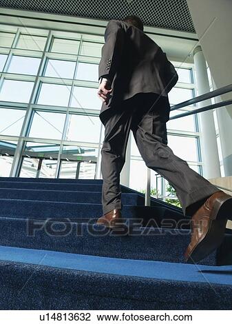 Businessman ascending office building stairs View Large Photo Image Stock Image - Businessman ascending office building stairs. Fotosearch