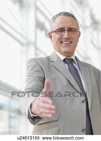 Stock Photography - Businessman extending hand to shake. Fotosearch