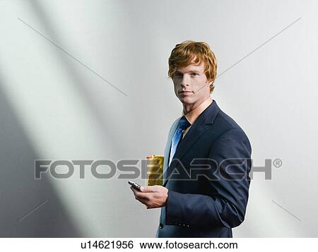 Businessman holding cell phone View Large Photo Image Stock Photograph - Businessman holding cell phone. Fotosearch
