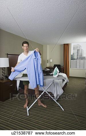 Businessman ironing shirt View Large Photo Image Stock Photo - Businessman ironing shirt . Fotosearch